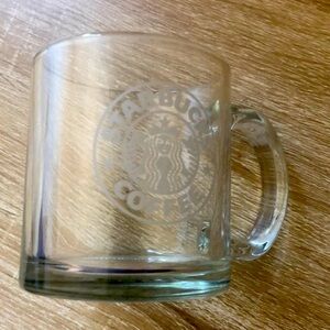 Clear glass Starbucks coffee mug.